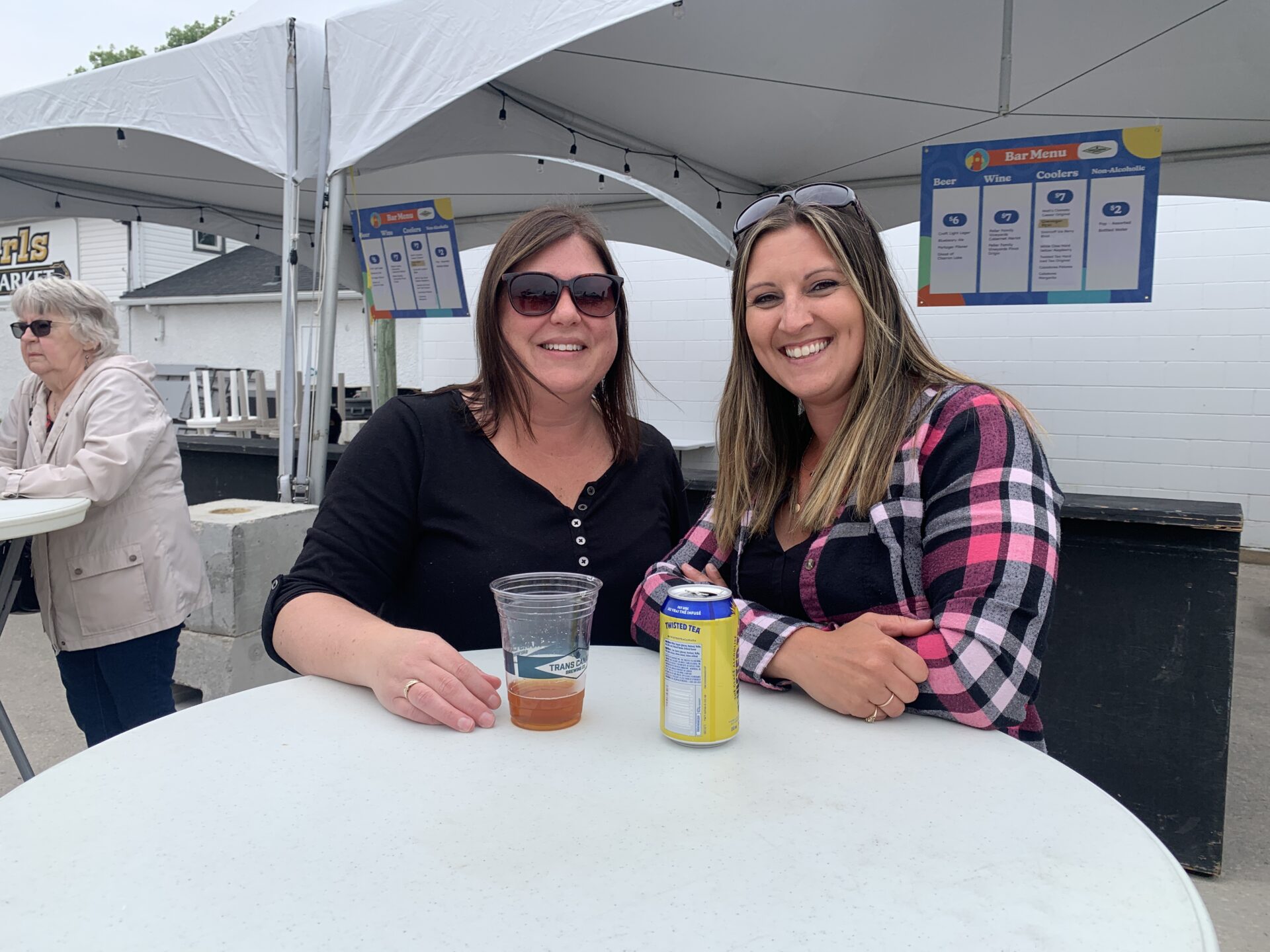 Two women enjoying drinks on patio